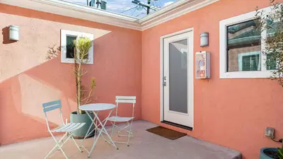 a patio with a table and chairs and a door at Rock n Roll by AvantStay in Los Angeles