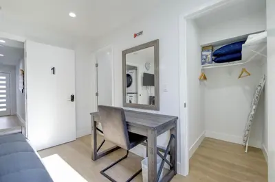 a dining room with a table and a mirror at Modern Apartment in Studio City in Los Angeles