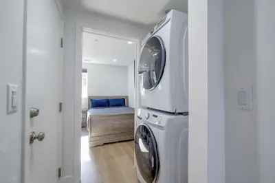 a laundry room with a washer and dryer in a house at Modern Apartment in Studio City in Los Angeles