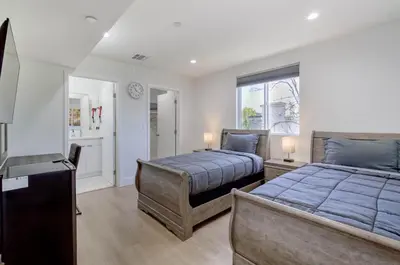 a bedroom with two beds and a window at Modern Apartment in Studio City in Los Angeles