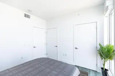 a bedroom with white cabinets and a bed with a potted plant at Top Floor High Rise 3 Bed DTLA Skyscraper Penthouse in Los Angeles