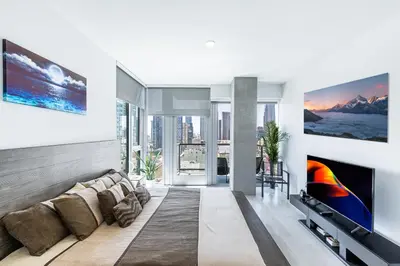 a living room with a couch and a tv at Top Floor High Rise 3 Bed DTLA Skyscraper Penthouse in Los Angeles