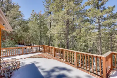 a wooden deck with a table and chairs on it at Pine Mountain Club Cabin Rental with Pool Access! in Pine Mountain Club