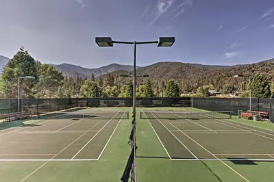 a tennis court with mountains in the background at Pine Mountain Club Cabin Rental with Pool Access! in Pine Mountain Club