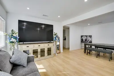 a living room with a large screen tv and a table at Home Between Los Angeles and Disney! Patio, Yard in Pico Rivera