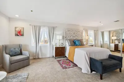 a bedroom with a bed and a chair and a couch at The Big Sky in Pearblossom