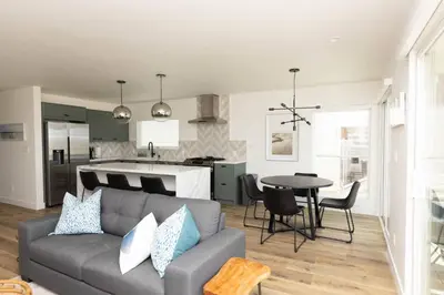 a living room and kitchen with a couch and a table at 5609 East Seaside Walk in Long Beach