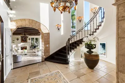 a staircase in a home with a vase of flowers at Bel Air Luxury Villa 6 bedrooms entire house Los Angeles in Los Angeles