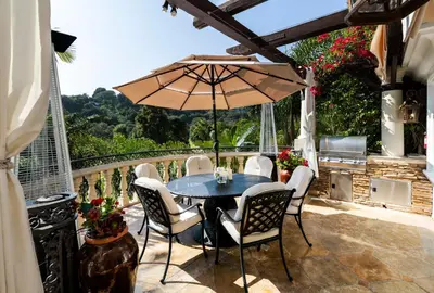 a table and chairs with an umbrella on a patio at Bel Air Luxury Villa 6 bedrooms entire house Los Angeles in Los Angeles