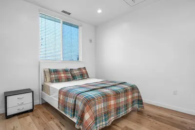 a white bedroom with a bed and a window at Cozy Oasis near Griffith Observatory in Los Angeles