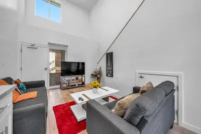 a living room with a couch and a table at Cozy Oasis near Griffith Observatory in Los Angeles