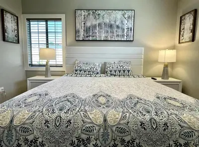 a large bed in a bedroom with two lamps at Orchard Villa Disneyland 5 Bedroom Pool Home Spa in Anaheim