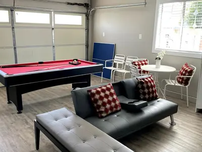 a living room with a pool table and a couch at Orchard Villa Disneyland 5 Bedroom Pool Home Spa in Anaheim