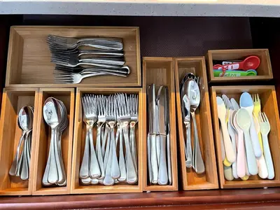 a drawer filled with utensils in a wooden box at Orchard Villa Disneyland 5 Bedroom Pool Home Spa in Anaheim