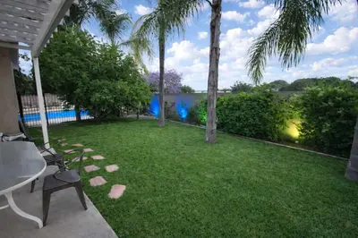 a yard with palm trees and a lawn with a chair at Disneyland Paradise 6 BedRoom 4 Bathroom Pool Spa Games in Anaheim