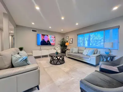 a living room with couches and a flat screen tv at Cypress Villa Disneyland 8 Bedroom 4Bath Pool Game in Anaheim
