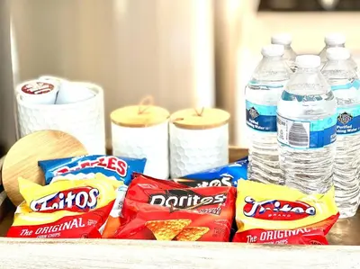 a table with chips and bottled water and bottles of water at Cozy house near Disney, Knott’s & Beach!! in Fullerton