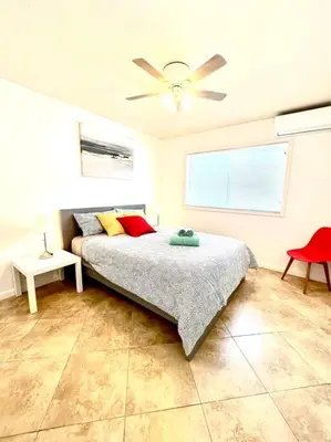 a bedroom with a bed and a ceiling fan at Cozy house near Disney, Knott’s & Beach!! in Fullerton