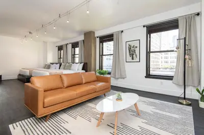 a living room with a couch and a bed at Audemar Boutique Hotel and Apartment Homes in Los Angeles