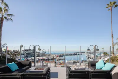 a view of a marina from a patio with couches at Redondo Beach 1BR w Pool Gym WD nr Beach LAX-615 in Redondo Beach