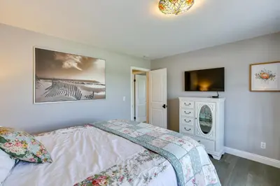 a bedroom with a bed and a tv on the wall at Stunning Home in Orange County with Stables! in Orange