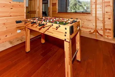 a wooden table with a bunch of guns on it at Circle Views by Big Bear Vacations Walk To Lake Boulder Bay Chalet in Big Bear Lake