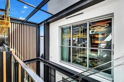 a balcony of a building with a window at SW Beach Hotel in Hermosa Beach