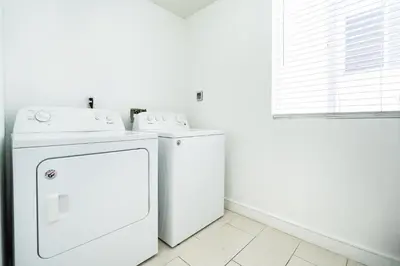 a white laundry room with a washer and dryer at Large Condo Sleeps 10 near Downtown Los Angeles in Los Angeles
