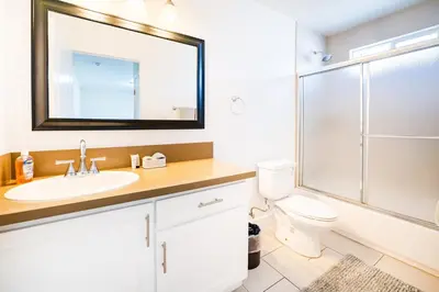 a bathroom with a sink and a toilet and a mirror at Large Condo Sleeps 10 near Downtown Los Angeles in Los Angeles