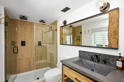 a bathroom with a sink and a toilet and a mirror at Le Chalet of Arrowbear Lake in Running Springs