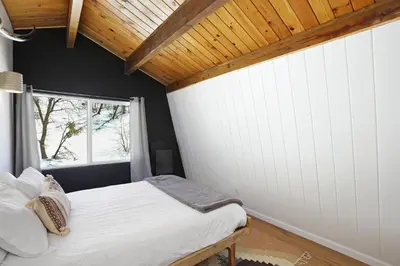 a bedroom with a bed and a window at Le Chalet of Arrowbear Lake in Running Springs